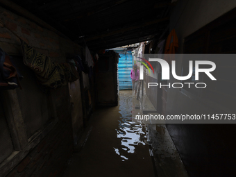 People are wading through flood water carrying their belongings and other items of necessity in Kathmandu, Nepal, on August 6, 2024. Nepal's...