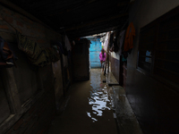 People are wading through flood water carrying their belongings and other items of necessity in Kathmandu, Nepal, on August 6, 2024. Nepal's...