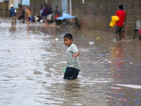 A boy is wading through flooded water on the embankments of Bagmati River in Balkhu of Kathmandu, Nepal, on August 6, 2024. Nepal's Meteorol...