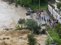 People are watching the flooded Bagmati River at Chovar in Kathmandu, Nepal, on August 6, 2024. Nepal's Meteorological Forecasting Division...