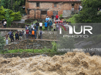 People are watching the flooded Bagmati River at Chovar in Kathmandu, Nepal, on August 6, 2024. Nepal's Meteorological Forecasting Division...