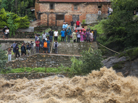 People are watching the flooded Bagmati River at Chovar in Kathmandu, Nepal, on August 6, 2024. Nepal's Meteorological Forecasting Division...