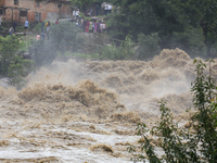 People are watching the flooded Bagmati River at Chovar in Kathmandu, Nepal, on August 6, 2024. Nepal's Meteorological Forecasting Division...