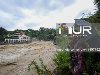 People are watching the flooded Bagmati River at Chovar in Kathmandu, Nepal, on August 6, 2024. Nepal's Meteorological Forecasting Division...