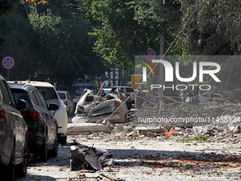 Debris is covering the ground near crushed cars after the Russian rocket attack in Kharkiv, Ukraine, on August 6, 2024. Russians are strikin...