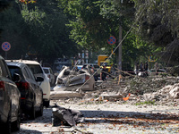 Debris is covering the ground near crushed cars after the Russian rocket attack in Kharkiv, Ukraine, on August 6, 2024. Russians are strikin...