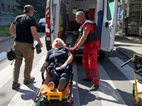 A paramedic is staying by a woman at an ambulance after the Russian rocket attack in Kharkiv, Ukraine, on August 6, 2024. Russians are strik...