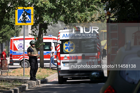 A law enforcer is standing by an ambulance after the Russian rocket attack in Kharkiv, Ukraine, on August 6, 2024. On Tuesday morning, Augus...