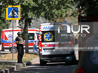 A law enforcer is standing by an ambulance after the Russian rocket attack in Kharkiv, Ukraine, on August 6, 2024. On Tuesday morning, Augus...