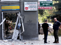 Men are standing by a damaged building after the Russian rocket attack in Kharkiv, Ukraine, on August 6, 2024. On Tuesday morning, August 6,...