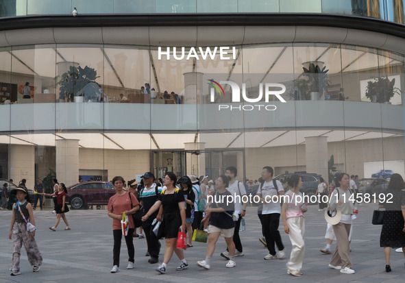 Visitors are passing a Huawei store on Wangfujing Pedestrian Street in Beijing, China, on August 6, 2024. 