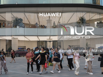 Visitors are passing a Huawei store on Wangfujing Pedestrian Street in Beijing, China, on August 6, 2024. (