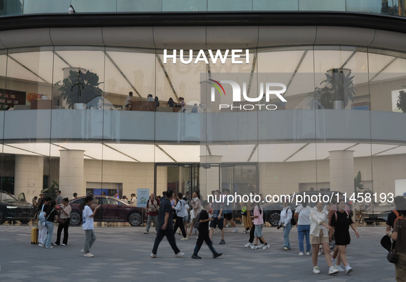 Visitors are passing a Huawei store on Wangfujing Pedestrian Street in Beijing, China, on August 6, 2024. 