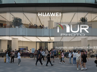 Visitors are passing a Huawei store on Wangfujing Pedestrian Street in Beijing, China, on August 6, 2024. (