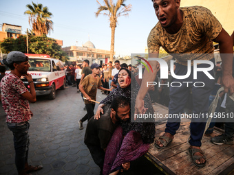 Palestinian medics are transporting an injured person following Israeli bombardment on Deir el-Balah into the Al-Aqsa Martyrs hospital in th...