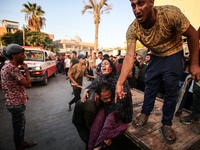 Palestinian medics are transporting an injured person following Israeli bombardment on Deir el-Balah into the Al-Aqsa Martyrs hospital in th...