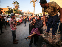 Palestinian medics are transporting an injured person following Israeli bombardment on Deir el-Balah into the Al-Aqsa Martyrs hospital in th...