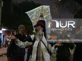 Pilgrims are waiting to enter the church of San Cayetano in Liniers, a working-class neighborhood of Buenos Aires, Argentina, on August 6, 2...