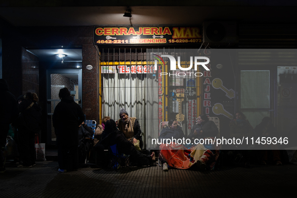 Pilgrims are waiting to enter the church of San Cayetano in Liniers, a working-class neighborhood of Buenos Aires, Argentina, on August 6, 2...