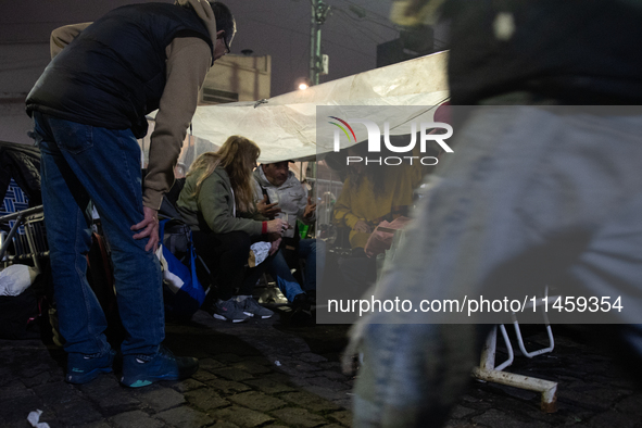 Pilgrims are waiting to enter the church of San Cayetano in Liniers, a working-class neighborhood of Buenos Aires, Argentina, on August 6, 2...