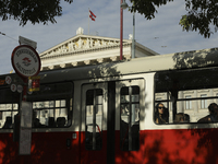 Passengers ride a tram past the Austrian Parliament in central Vienna early in the morning. Austria, Wednesday, August 7, 2024. (