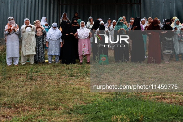 Kashmiri women are praying as Muslim devotees are taking part in Salatul Istisqa in Sopore, Jammu and Kashmir, India, on August 7, 2024, to...