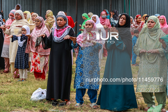 Kashmiri women are praying as Muslim devotees are taking part in Salatul Istisqa in Sopore, Jammu and Kashmir, India, on August 7, 2024, to...