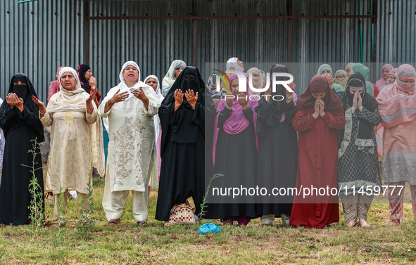 Kashmiri women are praying as Muslim devotees are taking part in Salatul Istisqa in Sopore, Jammu and Kashmir, India, on August 7, 2024, to...