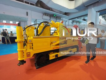 Visitors are visiting a ''Fully hydraulic deep-hole directional drilling rig for coal mines'' at the 2024 Beijing International Coal Mining...