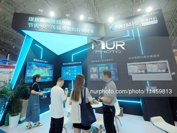 Visitors are visiting the ''Coal Video Sensing Compression'' system at the 2024 Beijing International Coal Mining Technology and Equipment E...