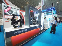 Visitors are visiting the ''Intelligent Automatic Drainage Device'' at the 2024 Beijing International Coal Mining Technology and Equipment E...