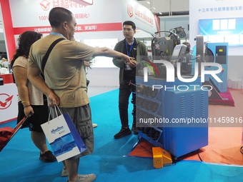 Visitors are visiting an ''Intelligent ultra-thin pipe press'' at the 2024 Beijing International Coal Mining Technology and Equipment Exhibi...