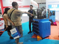 Visitors are visiting an ''Intelligent ultra-thin pipe press'' at the 2024 Beijing International Coal Mining Technology and Equipment Exhibi...