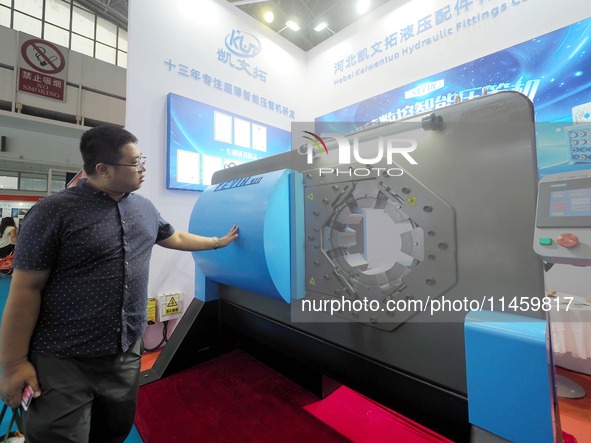 Visitors are visiting the ''Ultra-thin CNC intelligent pipe Press'' at the 2024 Beijing International Coal Mining Technology and Equipment E...