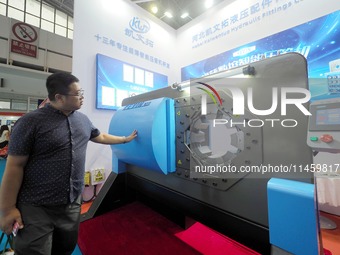 Visitors are visiting the ''Ultra-thin CNC intelligent pipe Press'' at the 2024 Beijing International Coal Mining Technology and Equipment E...