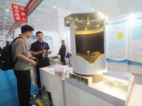 Visitors are viewing a model of the ''coal bunker cleaning robot'' at the 2024 Beijing International Coal Mining Technology and Equipment Ex...