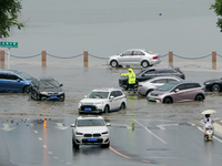 Vehicles are passing a waterlogged section of Binhai Middle Road in Yantai, China, on August 6, 2024. (