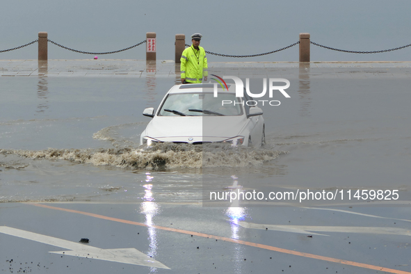 Vehicles are passing a waterlogged section of Binhai Middle Road in Yantai, China, on August 6, 2024. 