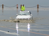 Vehicles are passing a waterlogged section of Binhai Middle Road in Yantai, China, on August 6, 2024. (