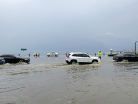 Vehicles are passing a waterlogged section of Binhai Middle Road in Yantai, China, on August 6, 2024. (