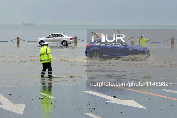 Vehicles are passing a waterlogged section of Binhai Middle Road in Yantai, China, on August 6, 2024. 