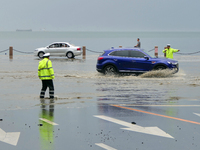 Vehicles are passing a waterlogged section of Binhai Middle Road in Yantai, China, on August 6, 2024. (