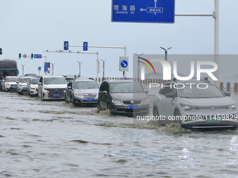 Vehicles are passing a waterlogged section of Binhai Middle Road in Yantai, China, on August 6, 2024. (