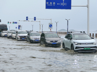 Vehicles are passing a waterlogged section of Binhai Middle Road in Yantai, China, on August 6, 2024. (