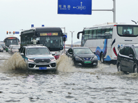 Vehicles are passing a waterlogged section of Binhai Middle Road in Yantai, China, on August 6, 2024. (