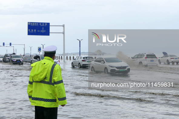 Vehicles are passing a waterlogged section of Binhai Middle Road in Yantai, China, on August 6, 2024. 