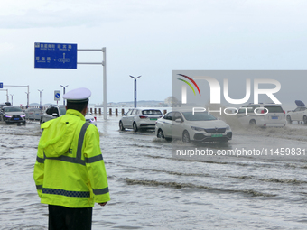 Vehicles are passing a waterlogged section of Binhai Middle Road in Yantai, China, on August 6, 2024. (