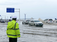 Vehicles are passing a waterlogged section of Binhai Middle Road in Yantai, China, on August 6, 2024. (