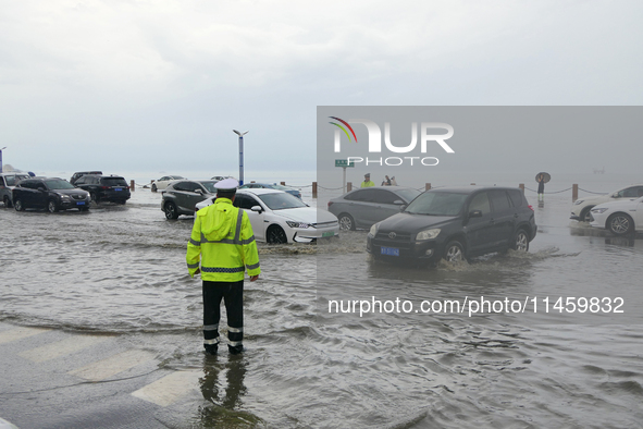 Vehicles are passing a waterlogged section of Binhai Middle Road in Yantai, China, on August 6, 2024. 