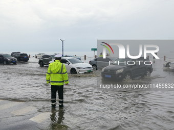 Vehicles are passing a waterlogged section of Binhai Middle Road in Yantai, China, on August 6, 2024. (